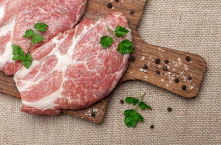 Raw fresh meat. Raw pork steak on a wooden board.Top view.の写真素材