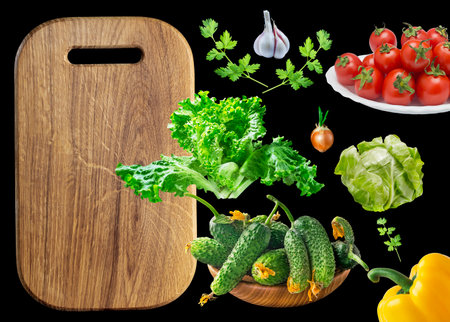 autumn vegetables tomatoes cucumbers salad garlic greens and cutting boardの写真素材