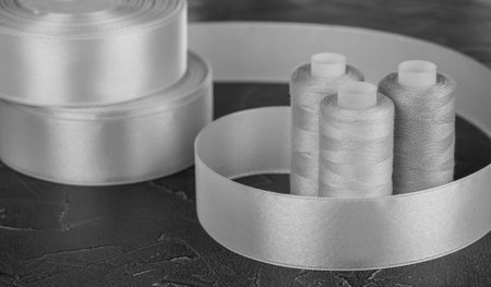Black and white sewing kit. bobbin threads and satin ribbon
