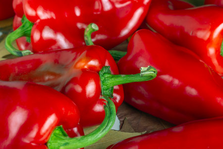 background of red bell pepper with green tailの写真素材