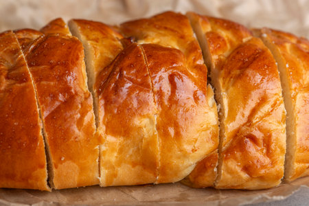 delicious freshly baked bun cut into pieces with close-up