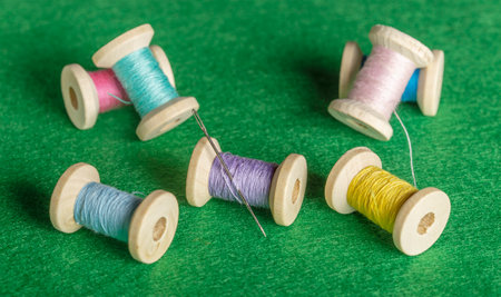 set of colored threads on wooden spools