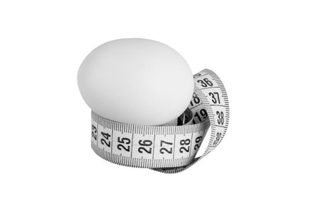 Weight loss diet with chicken egg and measuring tape isolated on white backgroundの写真素材