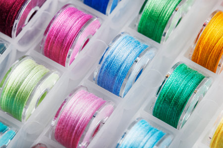 Plastic bobbins for a sewing machine with multi-colored threads.
