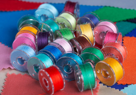 Plastic bobbins for a sewing machine with multi-colored threads.の写真素材