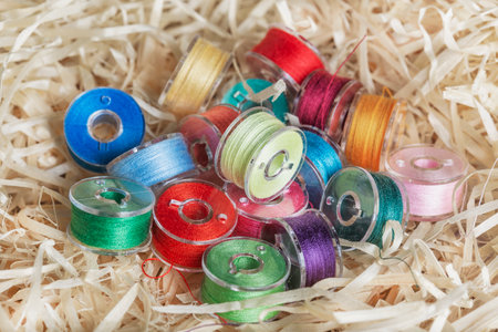 Plastic bobbins for a sewing machine with multi-colored threads.