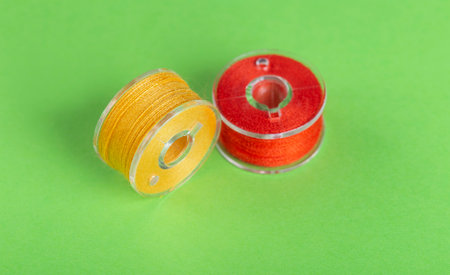 Plastic bobbins for a sewing machine with multi-colored threads.の写真素材