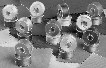 Plastic bobbins for sewing machine black and whiteの写真素材