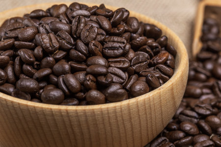 freshly roasted coffee beans in a wooden bowlの写真素材