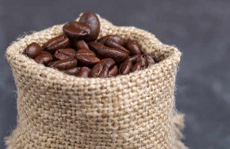 freshly roasted coffee beans in a burlap bagの写真素材