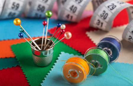 sewing kit, bobbins with colored threads, thimble for sewing.