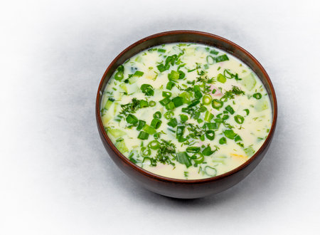 Summer cold soup okroshka with vegetables, sausage, herbs and kefir.の写真素材