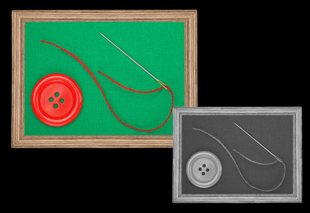 red button and needle with red thread in vintage style