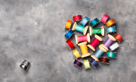 Amazing top view of colorful sewing threads on spools