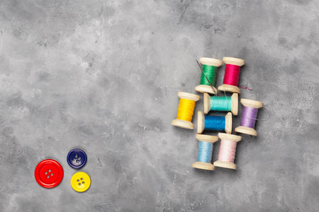 Amazing top view of colorful sewing threads and bobbins