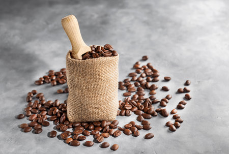 Burlap sack and scoop with brown roasted coffee beans.の写真素材