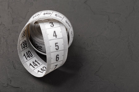 sewing tape measure for taking measurements on a black and white background