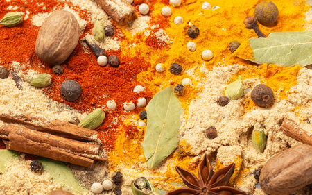 Bright background of spices turmeric, paprika, black and allspiceの写真素材