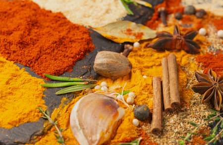Scattered spices: turmeric, paprika, cardamom, nutmeg, black and allspiceの写真素材