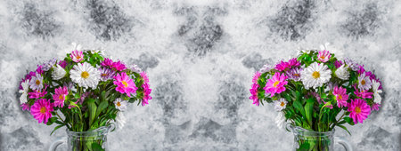 bouquet of white and pink flowers on a vintage background in a glass vaseの写真素材