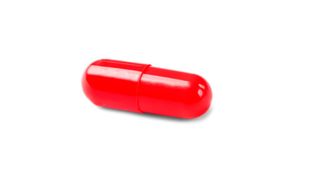 red capsule pill isolated on white backgroundの写真素材