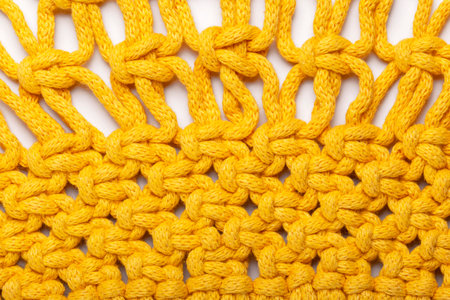 Bright background of yellow threads, macrame weaving