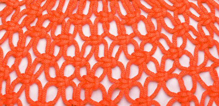 Bright background made of red threads, macrame weaving