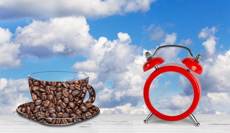 alarm clock and coffee against a blue skyの写真素材