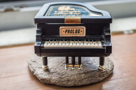 Black piano music box on wooden backgroundの写真素材