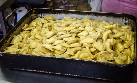 raw ravioli with potato and cheese during cookingの写真素材
