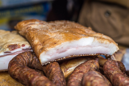 piece of raw smoked pork bacon and sausagesの写真素材