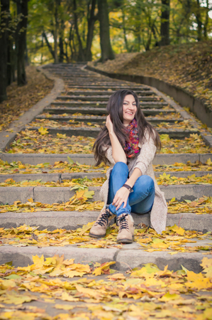 girl sitting on stone stepsの写真素材