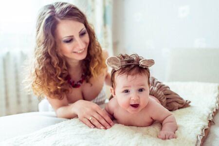 naked baby with mother