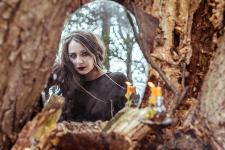 mystical woman looks in the mirrorの写真素材