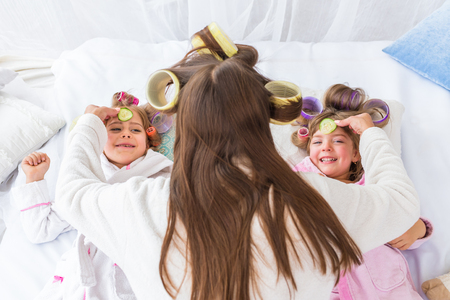 Woman and children on bedの写真素材