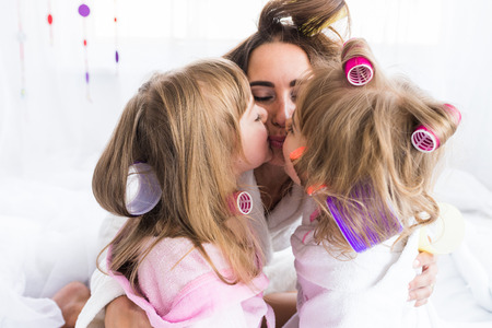 Woman and children on bedの写真素材