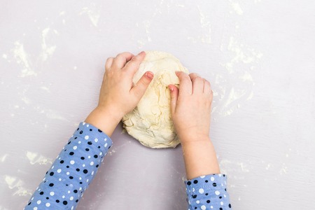 Children hands make a doughの写真素材
