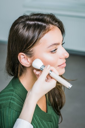Woman applying cosmeticの写真素材