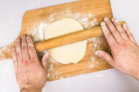 Man hands rolled dough