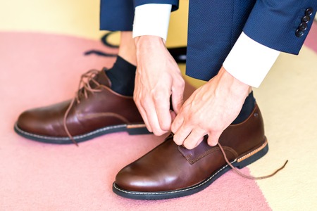 The man wears shoesの写真素材