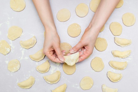 Womans hands make ravioliの写真素材