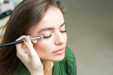 Brush applying beige makeupの写真素材