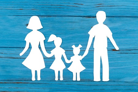 Closeup of happy paper family on blue backgroundの写真素材