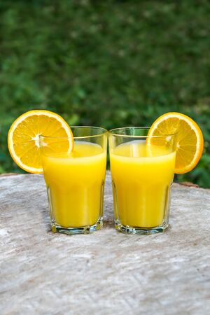 The two glasses of fresh orange juiceの写真素材