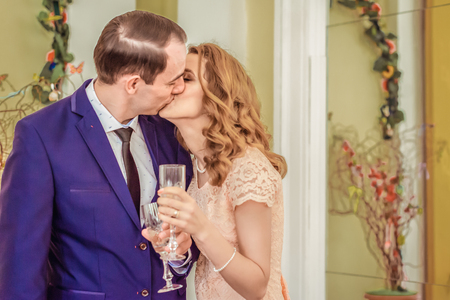 Man and woman kissing and drinking champagneの写真素材
