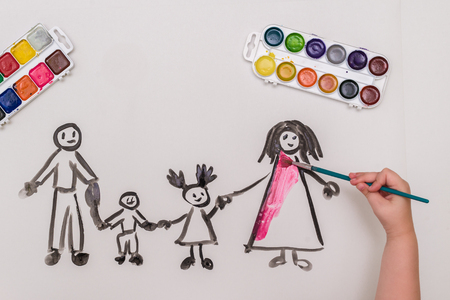 The childs hand paints a happy familyの写真素材