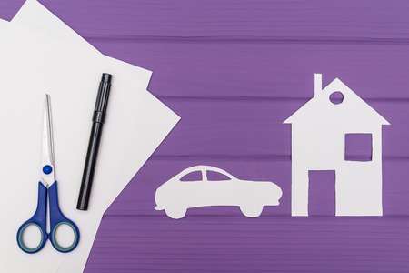 The silhouettes cut out of paper of car and houseの写真素材