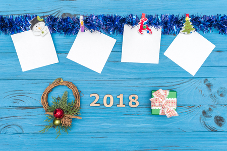 Paper stickers and New Year ornaments and toys on blue wooden backgroundの写真素材