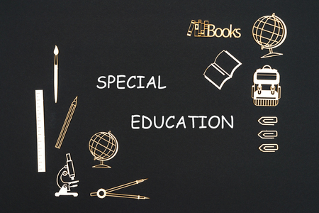 Wooden chipboard miniatures school supplies placed on blackboard with words special education. Concept special education schoolの写真素材