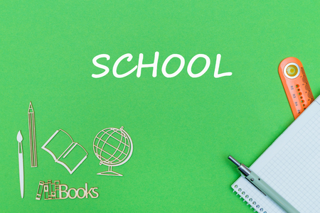 concept school, text school, school supplies, notebook, ruler and pen on green backboardの写真素材
